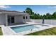 This home features a beautiful private pool, surrounded by brick pavers and a manicured lawn at 14065 Paris Ln, Port Charlotte, FL 33981