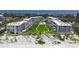 Scenic aerial view showing direct beach access and manicured common areas, showcasing this beachfront community at 1465 Gulf Of Mexico Dr # 502, Longboat Key, FL 34228