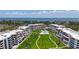 Aerial view of a beachfront property with a community pool, manicured lawns, and beautiful surrounding landscape at 1465 Gulf Of Mexico Dr # 502, Longboat Key, FL 34228