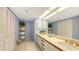 Bathroom with double sinks, decorative shelving, lots of counter space, and custom cabinetry at 1465 Gulf Of Mexico Dr # 502, Longboat Key, FL 34228