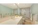 Bathroom featuring a spacious vanity with a sink, a large mirror, and a walk-in shower with glass doors at 1465 Gulf Of Mexico Dr # 502, Longboat Key, FL 34228