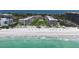 Gorgeous beach with white sand, palm trees, and emerald water showcasing the ideal coastal living experience at 1465 Gulf Of Mexico Dr # 502, Longboat Key, FL 34228