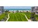 Beautiful beachfront with white sand, bridge to beach, and lush landscaping surrounding the property at 1465 Gulf Of Mexico Dr # 502, Longboat Key, FL 34228