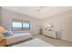 Bright and cozy bedroom featuring twin beds, printed wallpaper, and a window with a scenic view at 1465 Gulf Of Mexico Dr # 502, Longboat Key, FL 34228