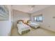 Bright and cozy bedroom features twin beds, printed wallpaper, and a window with a scenic view at 1465 Gulf Of Mexico Dr # 502, Longboat Key, FL 34228