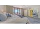 Bedroom featuring water views, access to a private outdoor deck, and a closet with a mirrored door at 1465 Gulf Of Mexico Dr # 502, Longboat Key, FL 34228
