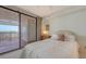 Bedroom with a bed that has white linens and a walkout patio showcasing beautiful ocean views in the background at 1465 Gulf Of Mexico Dr # 502, Longboat Key, FL 34228