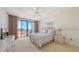Bright bedroom with large glass doors to balcony, neutral carpet, and traditional furniture at 1465 Gulf Of Mexico Dr # 502, Longboat Key, FL 34228