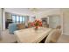 Bright dining area features a marble table, a chandelier, and an open living space at 1465 Gulf Of Mexico Dr # 502, Longboat Key, FL 34228