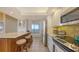 Bright kitchen bar area with stainless steel appliances, tiled backsplash, and an adjacent window at 1465 Gulf Of Mexico Dr # 502, Longboat Key, FL 34228