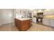 Bright kitchen features white cabinets, island with seating, and modern appliances at 1465 Gulf Of Mexico Dr # 502, Longboat Key, FL 34228