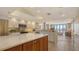Bright, open kitchen with stainless steel appliances, tiled backsplash, and an adjacent living area with balcony access at 1465 Gulf Of Mexico Dr # 502, Longboat Key, FL 34228