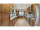 Modern kitchen with wood cabinetry, granite countertops, and stainless steel appliances at 1465 Gulf Of Mexico Dr # 502, Longboat Key, FL 34228