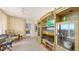 Cozy living area with custom shelving, a glass table and chairs, and balcony access with ocean views at 1465 Gulf Of Mexico Dr # 502, Longboat Key, FL 34228