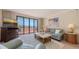 Bright living room with sliding doors to a balcony with ocean views at 1465 Gulf Of Mexico Dr # 502, Longboat Key, FL 34228