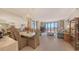 Bright and airy living room boasts modern decor, a spacious layout, and sliding doors to a balcony at 1465 Gulf Of Mexico Dr # 502, Longboat Key, FL 34228