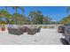 Inviting outdoor patio with comfortable seating, planters, and grill for entertaining at 1465 Gulf Of Mexico Dr # 502, Longboat Key, FL 34228