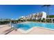 Inviting swimming pool surrounded by greenery and comfortable lounge chairs at 1465 Gulf Of Mexico Dr # 502, Longboat Key, FL 34228