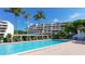 Beautiful pool area with lush landscaping and lounging spaces for relaxation at 1465 Gulf Of Mexico Dr # 502, Longboat Key, FL 34228