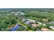 Beautiful aerial view of property showcasing lush landscaping, pond, and community at 15006 21St E Ave, Bradenton, FL 34212