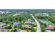 Overhead shot of real estate, showing lush landscaping and a serene pond with surrounding residences at 15006 21St E Ave, Bradenton, FL 34212