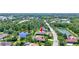 Aerial view of the home with lush green landscaping and a pond nearby at 15006 21St E Ave, Bradenton, FL 34212