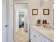 Bathroom featuring tile floors, a marble countertop, and access to the bedroom at 15006 21St E Ave, Bradenton, FL 34212