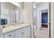 Bathroom featuring a marble vanity, tile floors, and access to the walk-in closet at 15006 21St E Ave, Bradenton, FL 34212