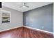 This bedroom offers hardwood floors, neutral paint and a ceiling fan at 15006 21St E Ave, Bradenton, FL 34212