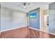 The spacious bedroom has wood floors, neutral walls, and a mounted television at 15006 21St E Ave, Bradenton, FL 34212