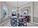 Dining area with a chandelier and adjacent storage cabinet at 15006 21St E Ave, Bradenton, FL 34212