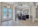 Open-concept dining area with chandelier and furniture piece visible from front entry at 15006 21St E Ave, Bradenton, FL 34212