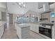 Modern kitchen with granite countertops, island, stainless appliances, and ample cabinet space at 15006 21St E Ave, Bradenton, FL 34212
