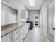 The spacious laundry room features plenty of storage and stone countertops at 15006 21St E Ave, Bradenton, FL 34212