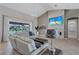 Inviting living room with stone accent wall and sliding glass doors leading to the lanai at 15006 21St E Ave, Bradenton, FL 34212