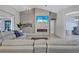 Living room with stone accent wall, electric fireplace, and views of the lanai at 15006 21St E Ave, Bradenton, FL 34212