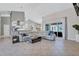 Open-concept living room features a vaulted ceiling and sliding glass doors to the lanai at 15006 21St E Ave, Bradenton, FL 34212