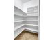 Walk-in pantry with tile floors and adjustable white shelving at 15006 21St E Ave, Bradenton, FL 34212