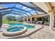 Patio features a screened in pool, jacuzzi, columns, lounge seating, and brick tiling at 15006 21St E Ave, Bradenton, FL 34212
