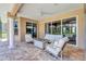 Outdoor patio featuring modern white lounge furniture, fire pit, and columns at 15006 21St E Ave, Bradenton, FL 34212