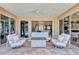 Patio featuring modern white lounge furniture, fire pit, and view through the house at 15006 21St E Ave, Bradenton, FL 34212