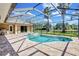 Home exterior featuring a screened in pool area, with brick tiling and columns at 15006 21St E Ave, Bradenton, FL 34212