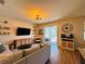 Cozy living room with modern decor, featuring a view of the backyard and pool at 15207 Searobbin Dr, Lakewood Ranch, FL 34202