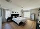 Spacious main bedroom with a chandelier, white walls, and luxury decor at 15207 Searobbin Dr, Lakewood Ranch, FL 34202