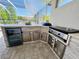 Outdoor kitchen with built in appliances, storage, beverage refrigerator and counter seating at 15207 Searobbin Dr, Lakewood Ranch, FL 34202