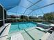 Backyard pool with attached spa and shallow tanning ledge surrounded by clear skies and landscaping at 15207 Searobbin Dr, Lakewood Ranch, FL 34202