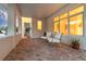 Cozy covered outdoor patio with brick flooring, comfortable seating, and bright, inviting natural light at 1642 Arlington St, Sarasota, FL 34239