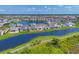 Wide aerial view showcasing a residential community next to a large lake at 17122 Ranchside Pl, Bradenton, FL 34211