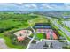 An aerial view of a community park including tennis courts, playground, baseball field, and a walking path at 17122 Ranchside Pl, Bradenton, FL 34211