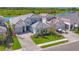 Aerial view of the home showcasing the meticulously landscaped yard, lake view, and three-car garage at 17122 Ranchside Pl, Bradenton, FL 34211